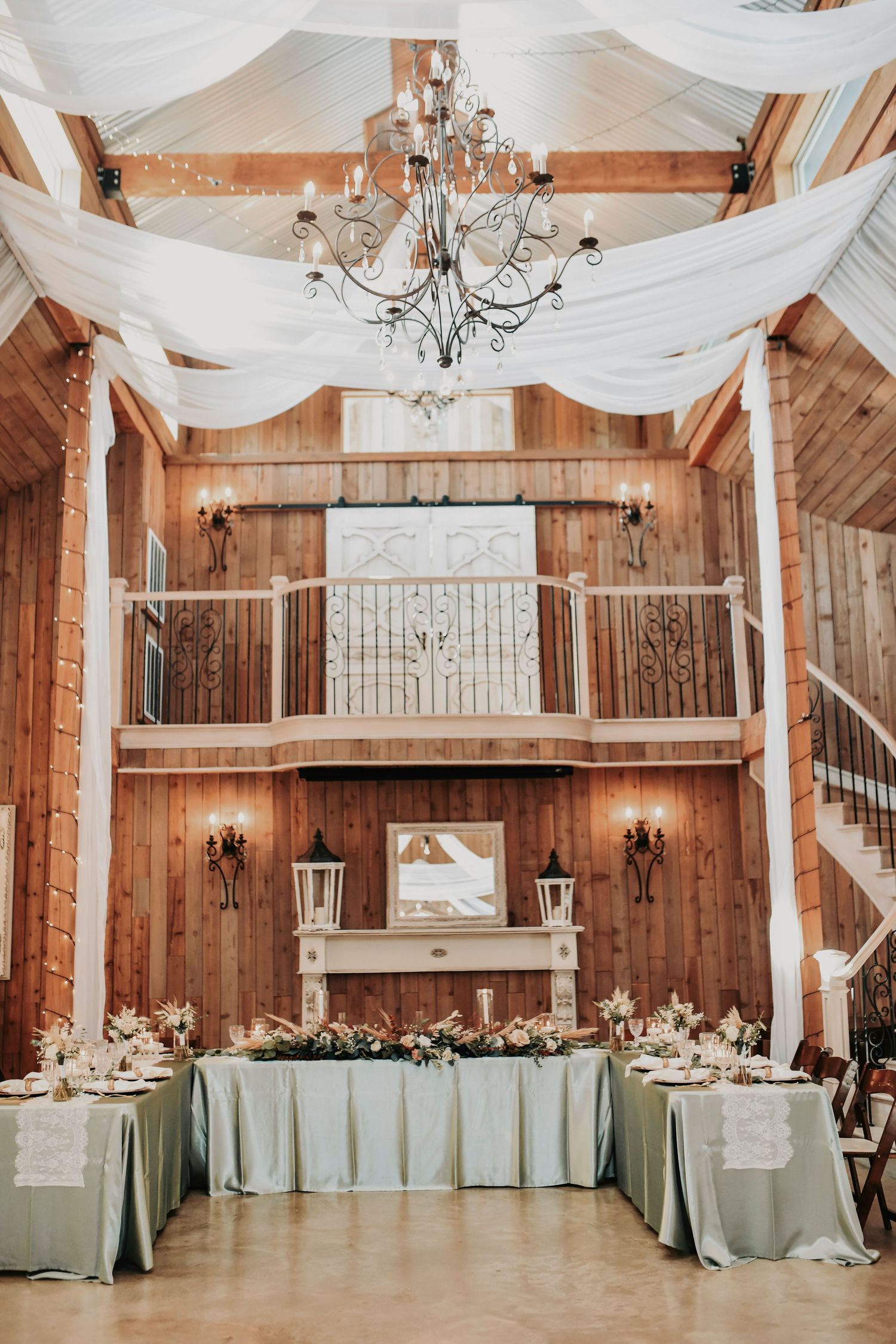 Elegant boho-inspired wedding décor with greenery runners and glowing candlelight