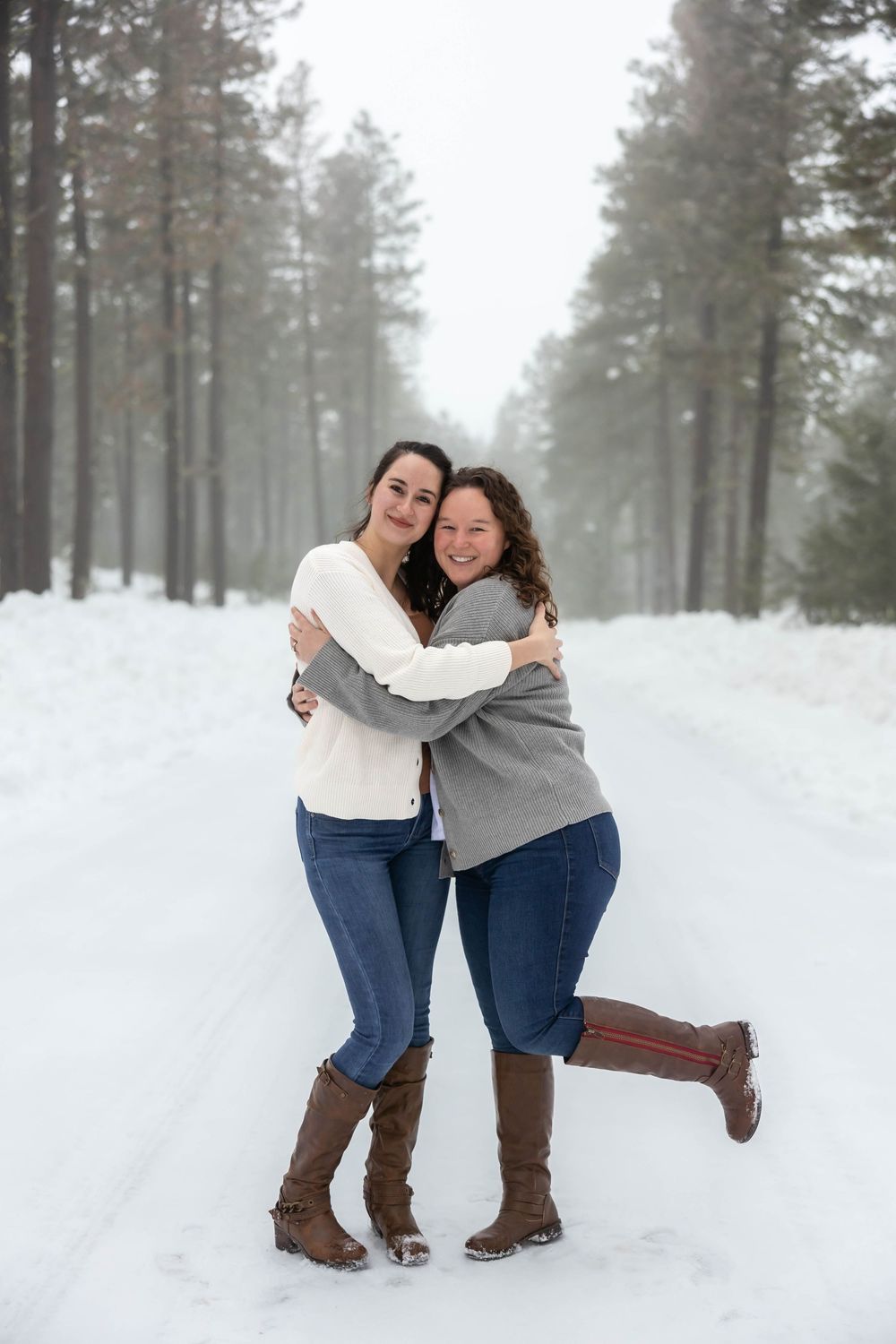 Candid moments of joy captured between two people playing in deep winter snow.