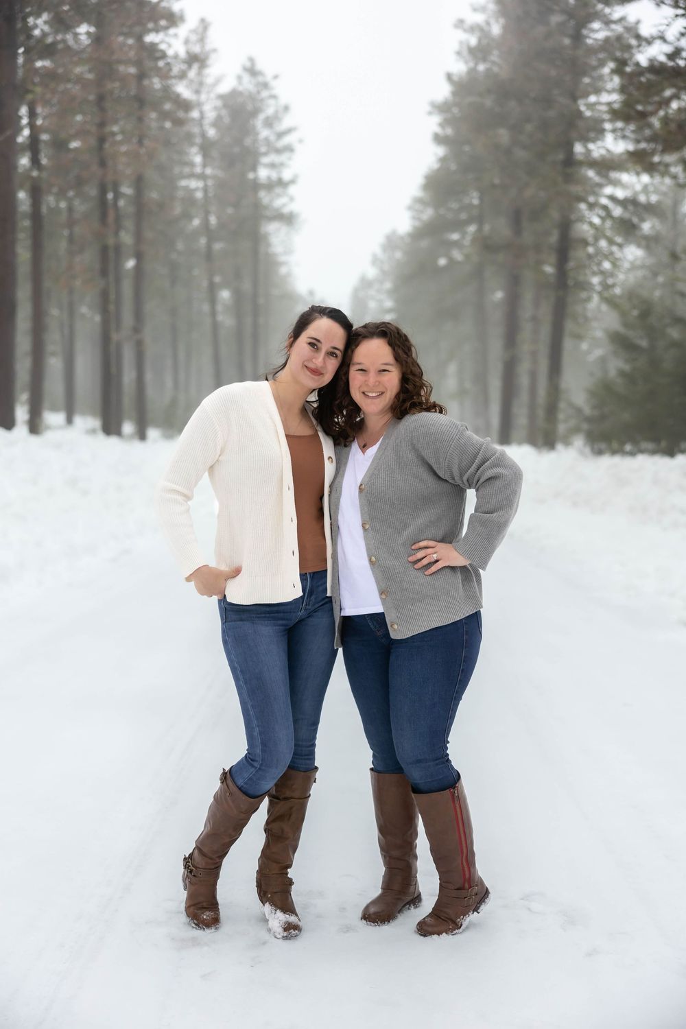 Playful winter portraits of two people in coordinated outfits against snowy forest.