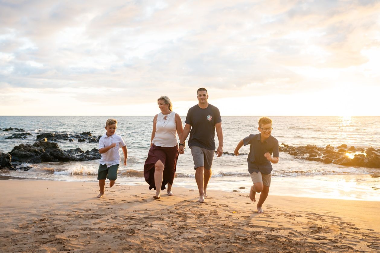 Maui family photographer photo against beautiful Maui sunset beach by ohwowfotos.
