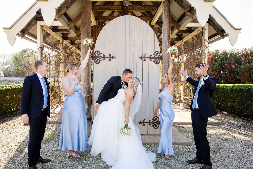 A series of outdoor wedding photos showing couples at a rustic barn venue with bridesmaids in light blue dresses.