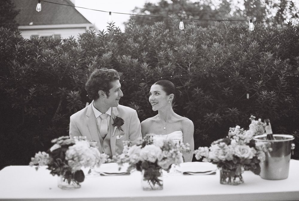 A romantic black and white photo montage captures seven special moments from a wedding celebration including dancing, dining and embraces.