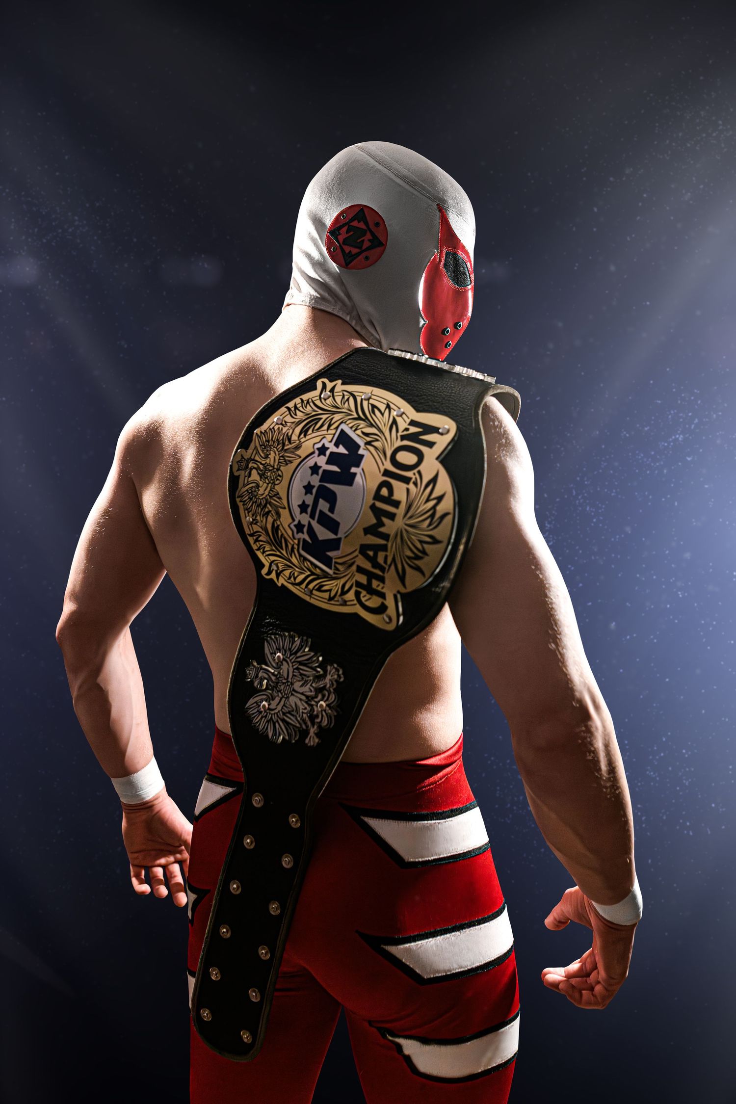 Professional wrestler in red and black attire poses dramatically against dark background with championship belt.