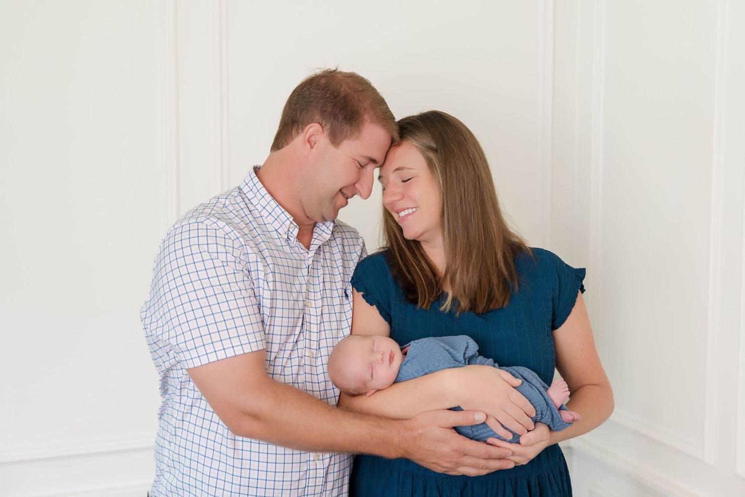 Three photos show tender family moments between parents and their newborn baby in a bright indoor setting.