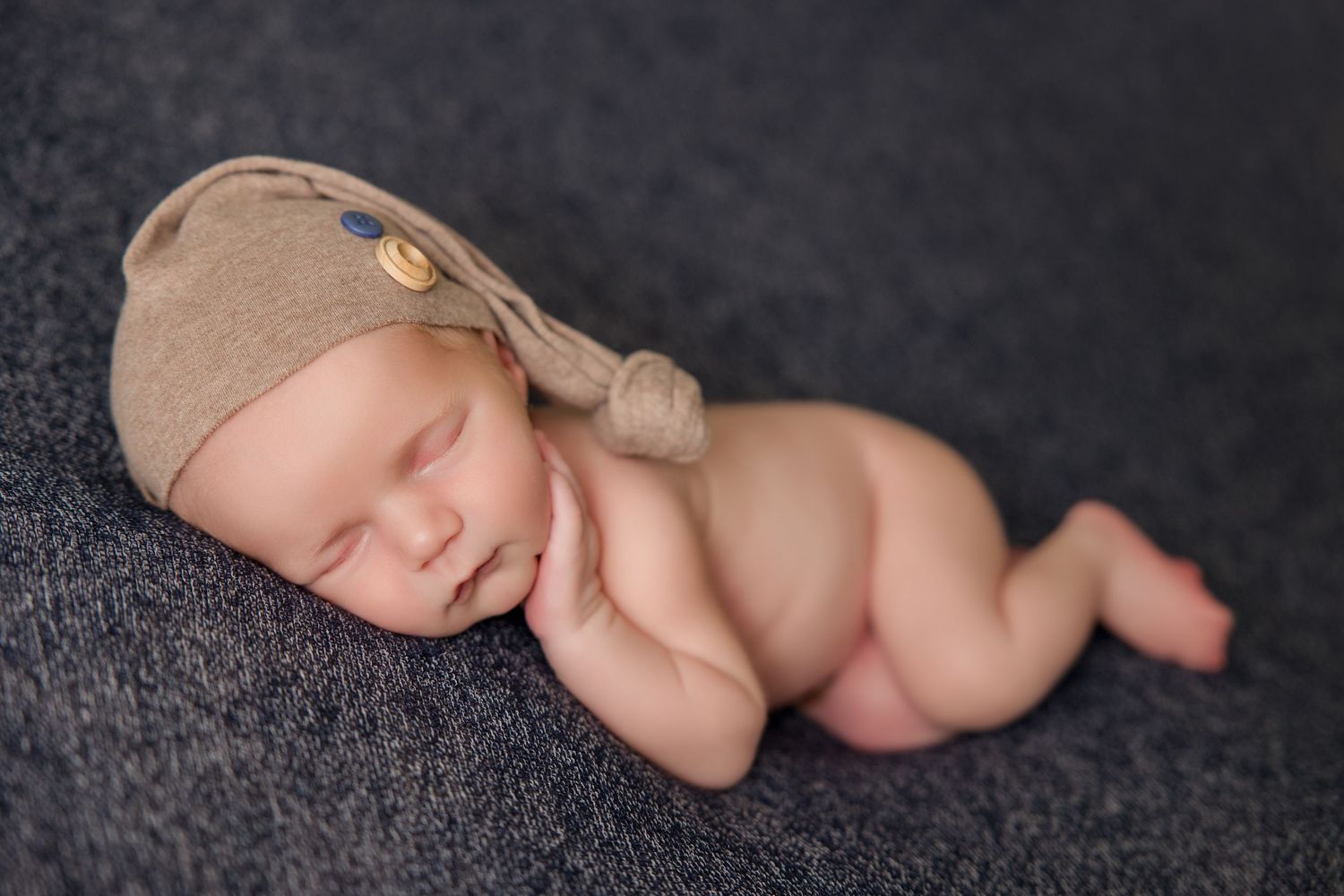 A series of six black and white artistic photographs showcasing a newborn baby's tiny fingers and toes against a dark background.