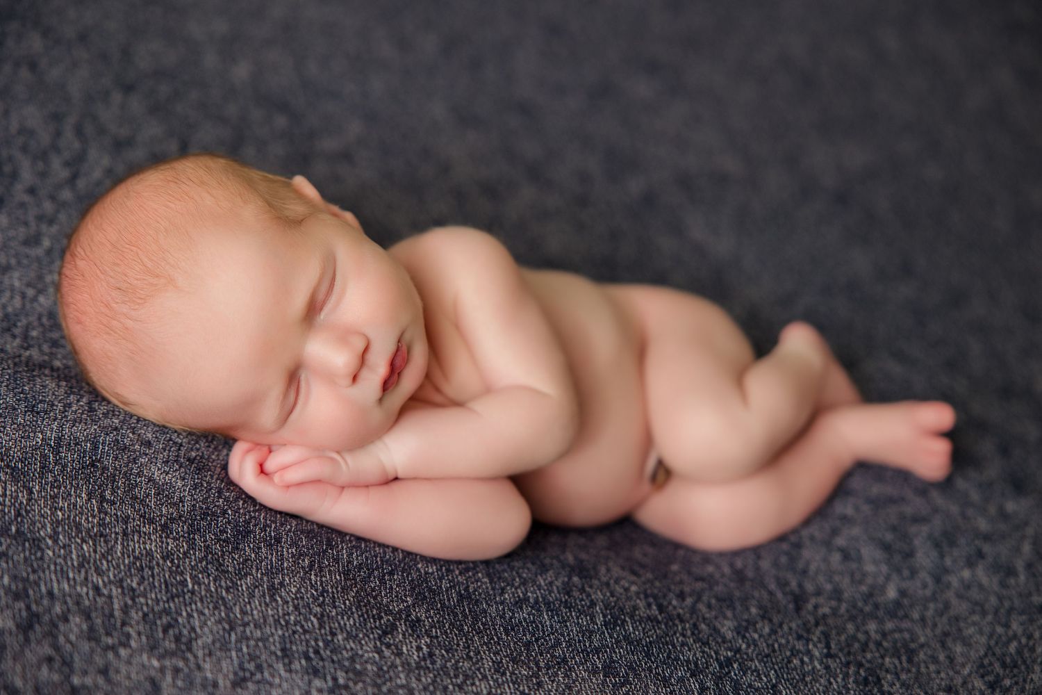 A black and white artistic newborn photography composition showing multiple sleeping poses against dark backdrop.
