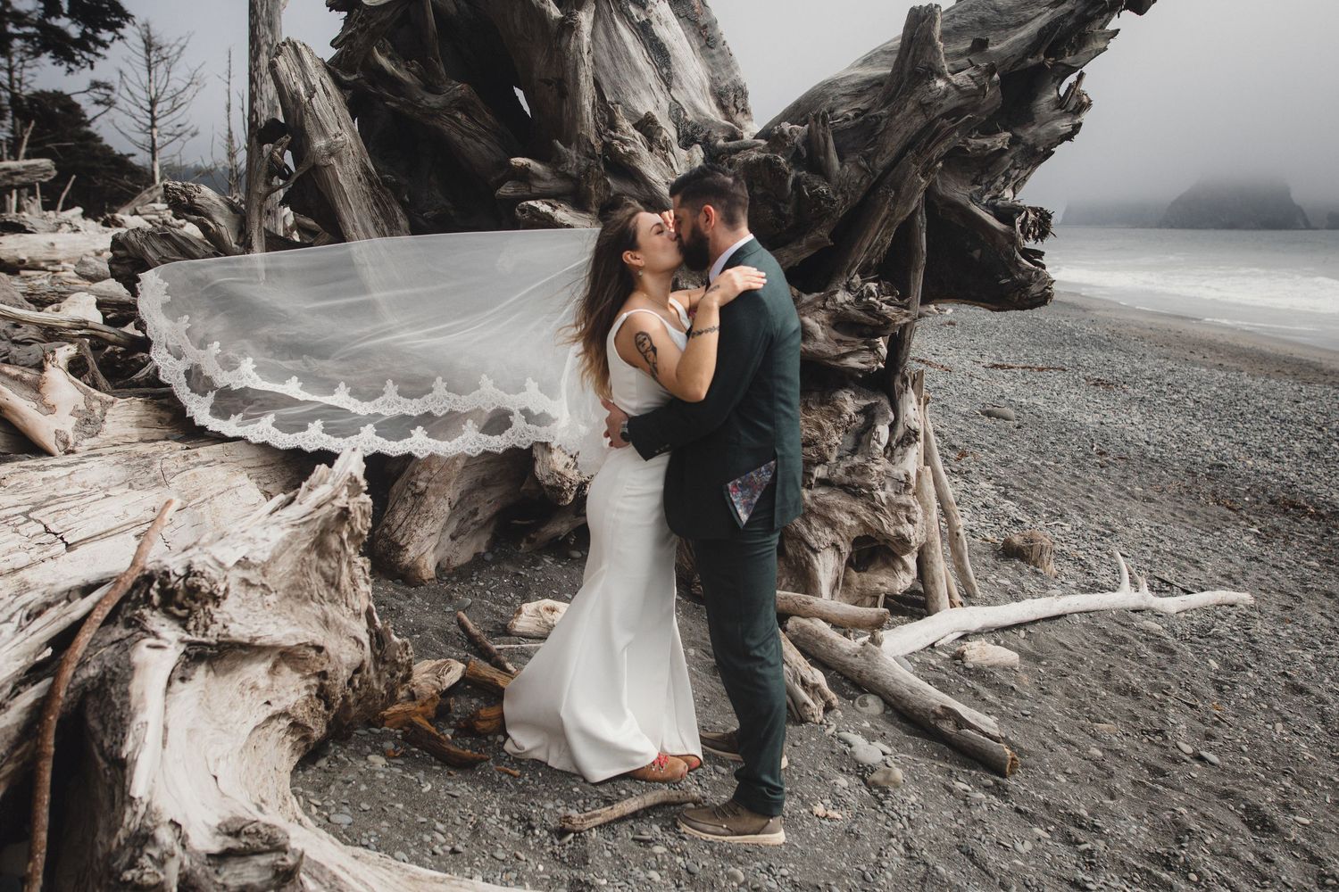 Couple kissing after their elopement ceremony on Rialto Beach in Washington's Olympic national park