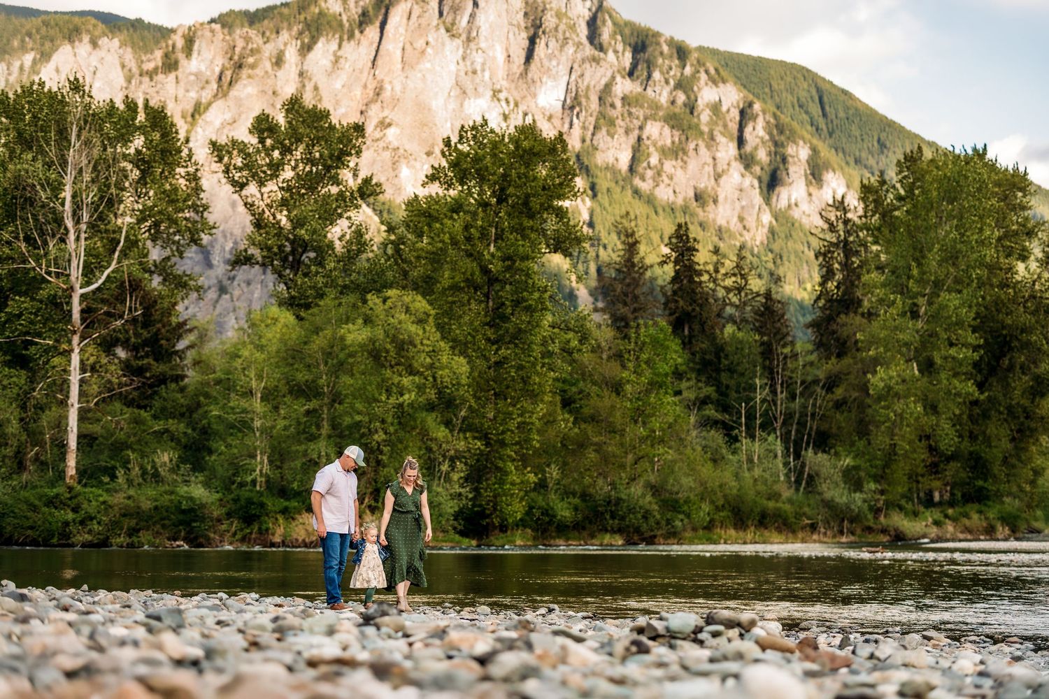 Scenic mountain landscape with rocky cliffs and green forest along a riverbed.