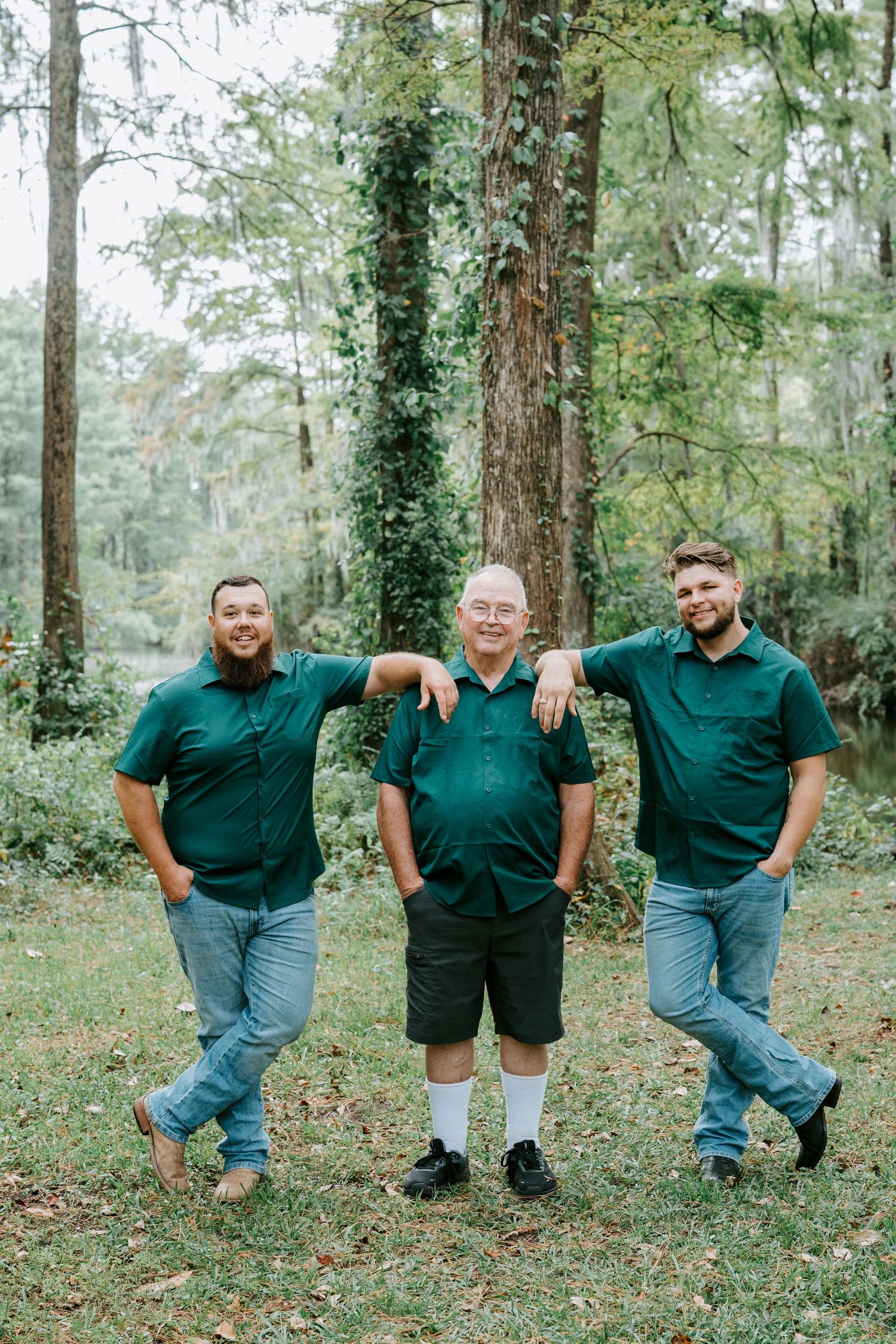 A sequence of three playful outdoor photos showing people in matching dark green shirts posing in a wooded setting.