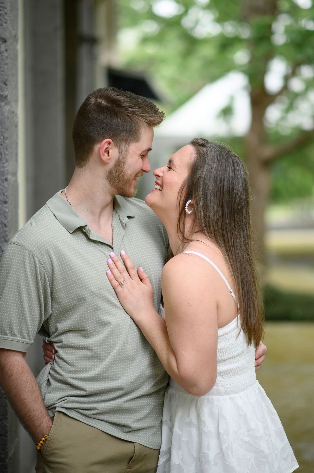 A romantic outdoor engagement photo session shows tender moments between a couple in a natural setting.