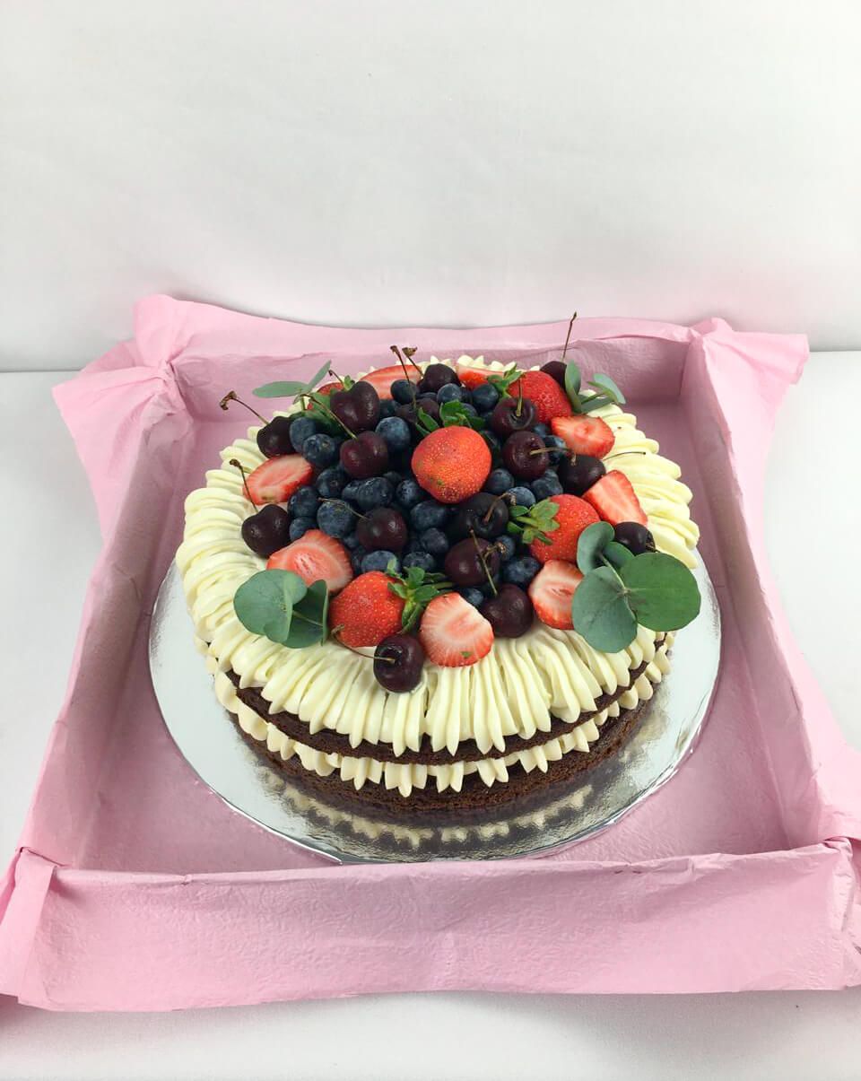 Carrot cake covered in fresh fruit delivered to a client in Howick South Africa.