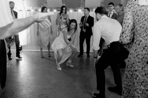 Wedding reception guests dancing and celebrating on a dance floor.