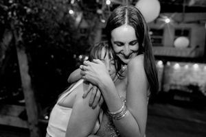 Black and white candid moments of wedding guests laughing and celebrating.