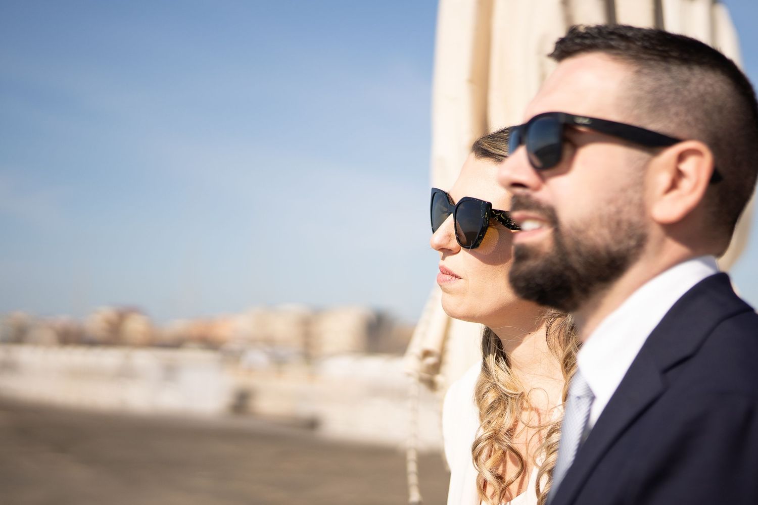 Three candid photos showing a bride and groom in sunglasses during a beach wedding ceremony on a sunny day.