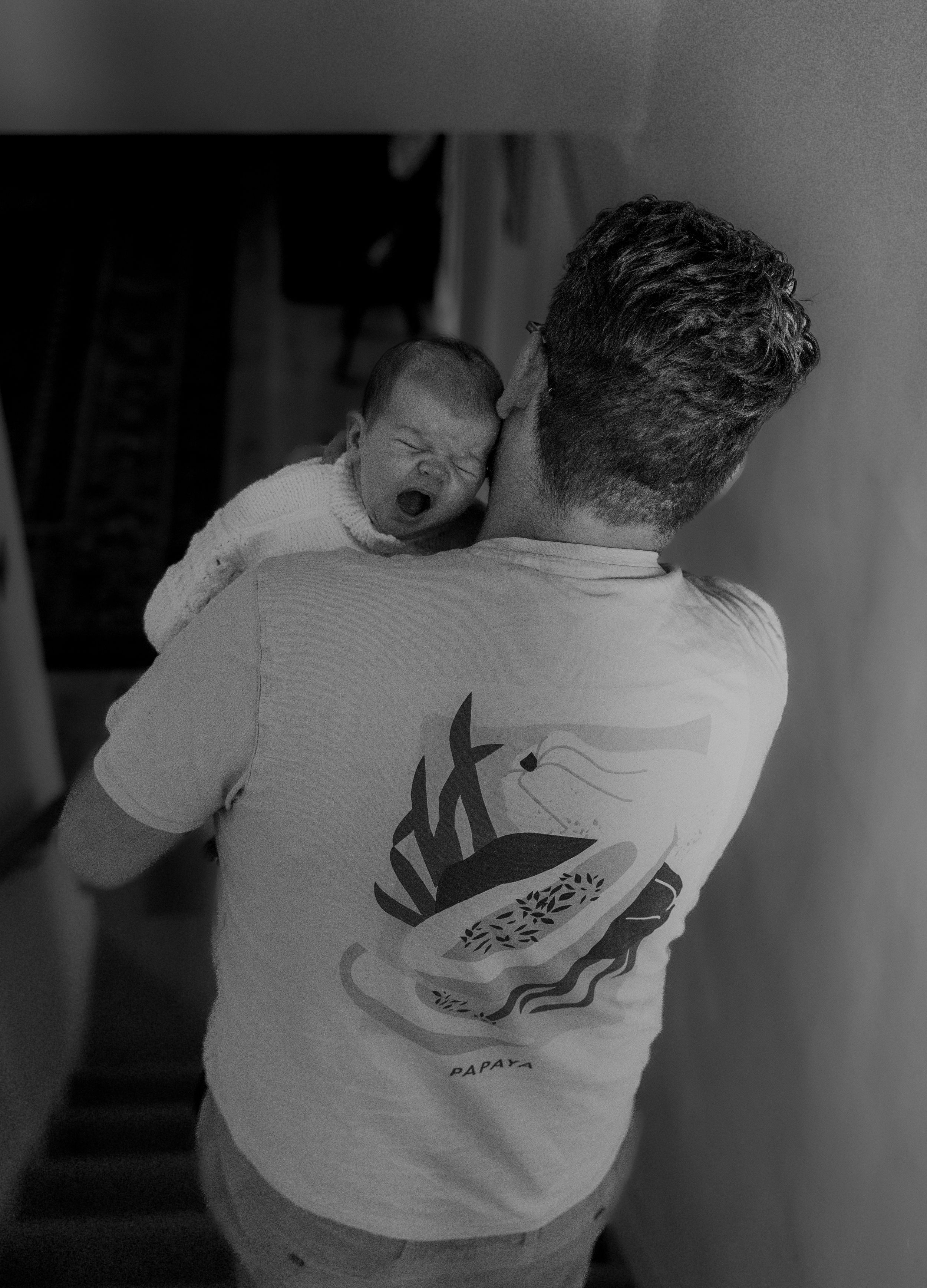 Black and white photo series showing the back of a person wearing a white t-shirt with different artistic designs.