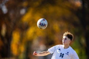 Soccer player ball in air