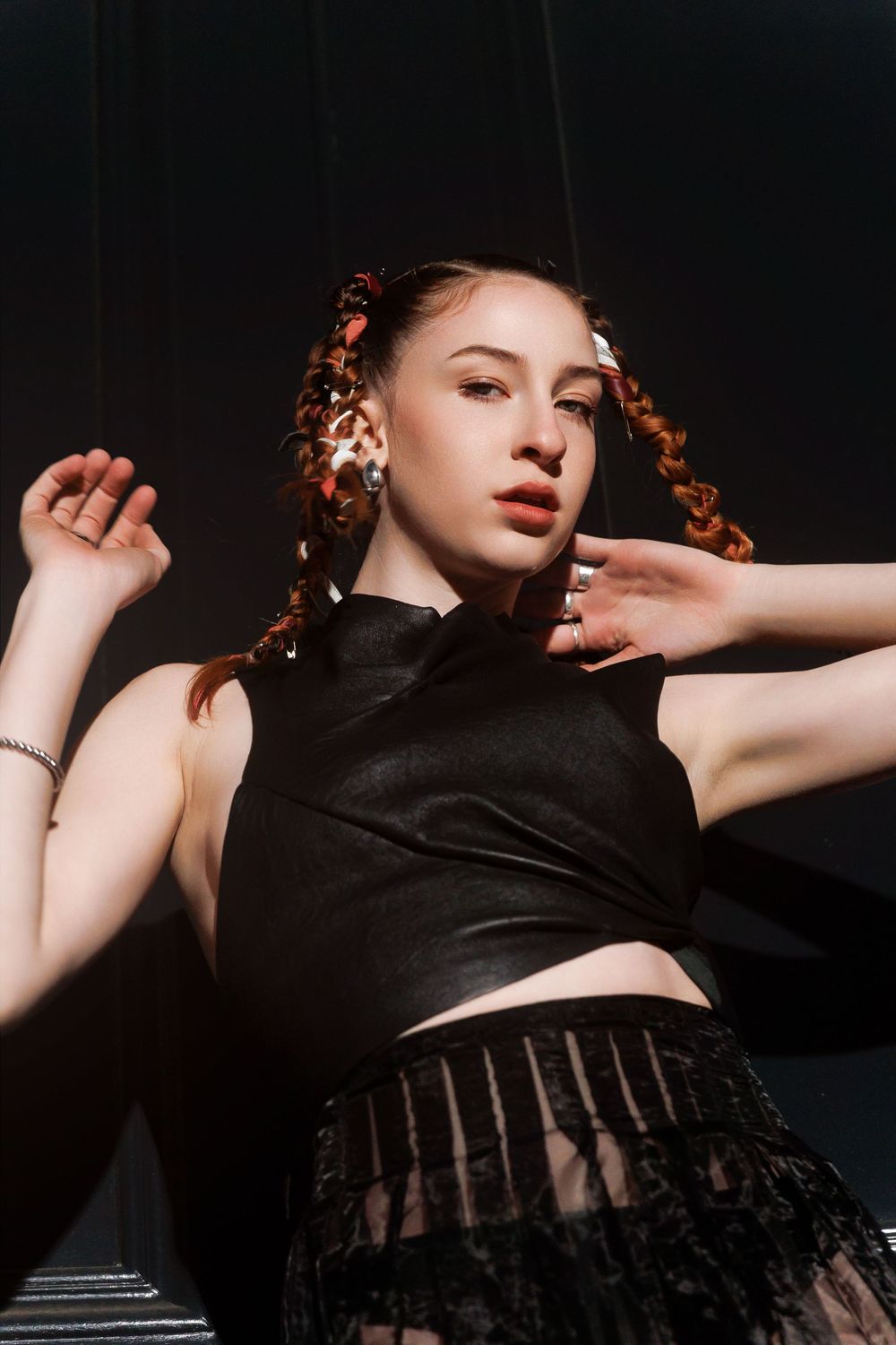 A sequence of dramatic boudoir portraits in dark lighting with artistic poses on black background.