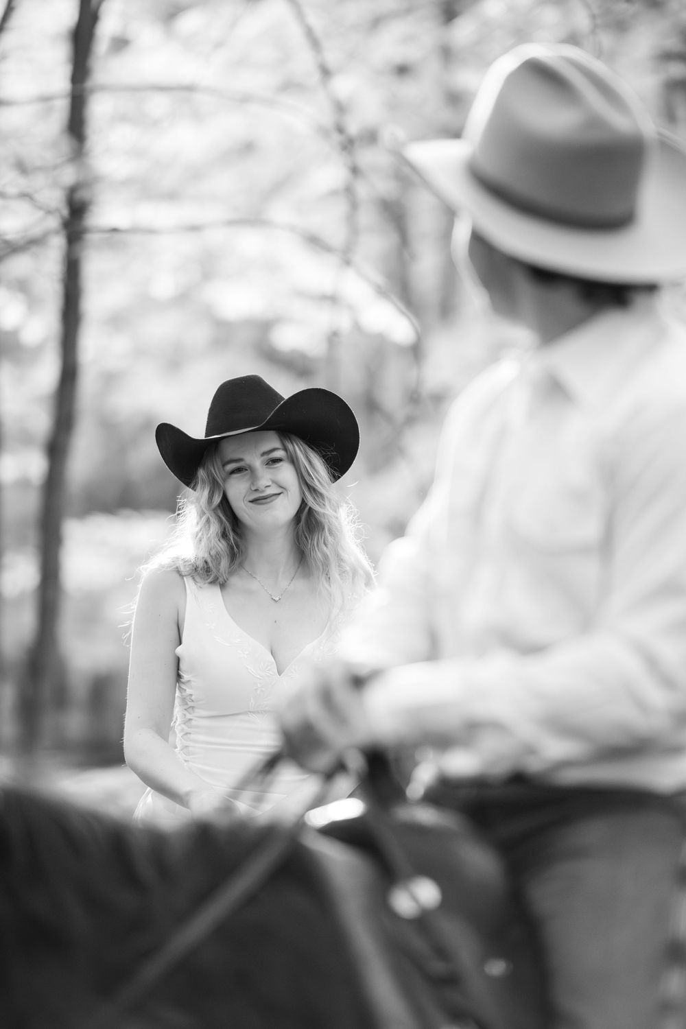 A black and white photo series showing a couple wearing cowboy hats in a rustic outdoor setting.