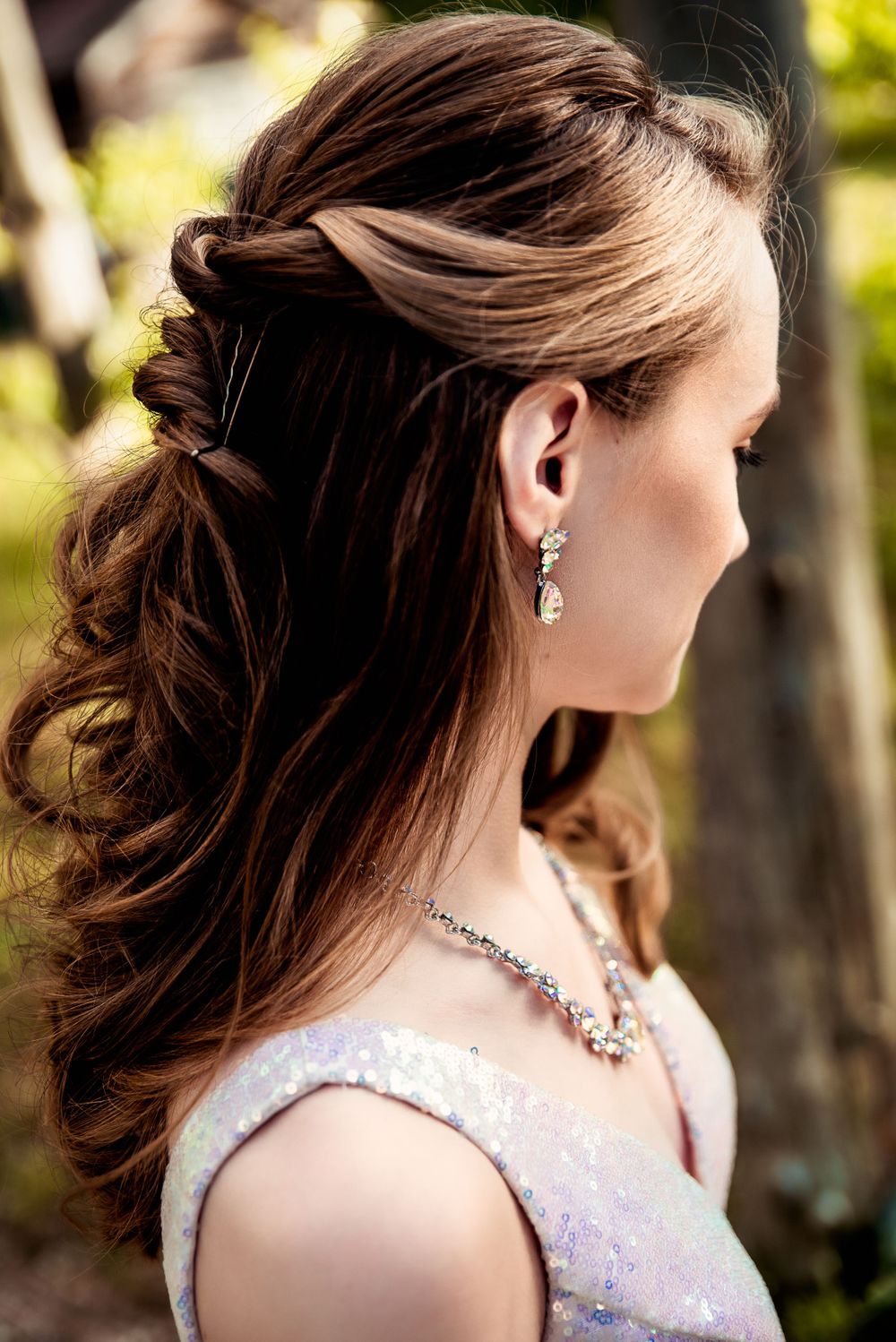 Teen showing the details of her hair and makeup for her prom look