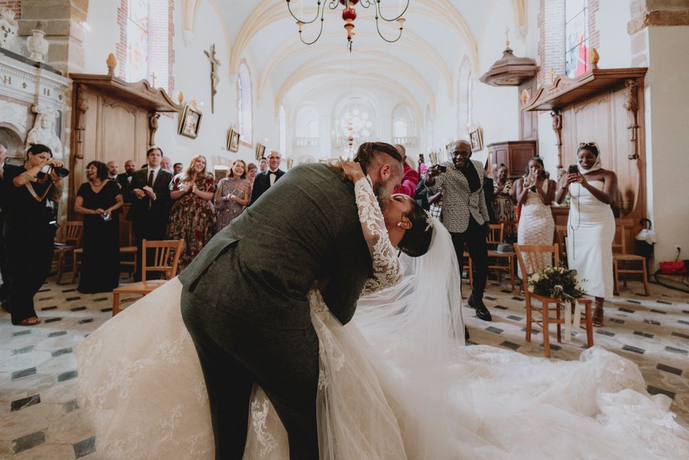 Emotional exchange of vows at chapel of Chateau de Vallery captured in natural light