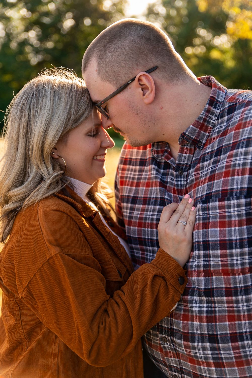 Intimate close-up of couple sharing tender moments in warm autumn sunlight.