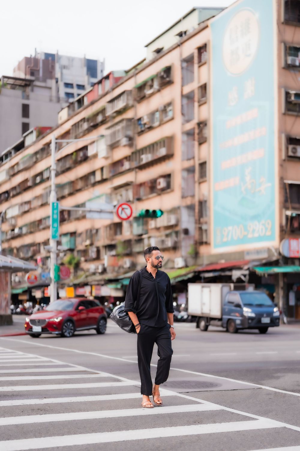a man crossing the street in Taipei city