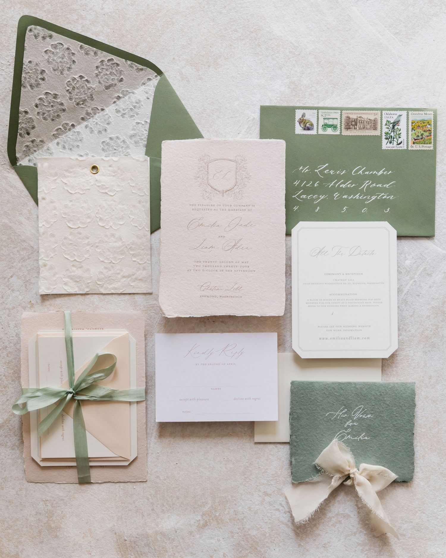 Elegant sage green and ivory wedding invitation suite with lace envelope liner, ribbon details, and vintage stamps.