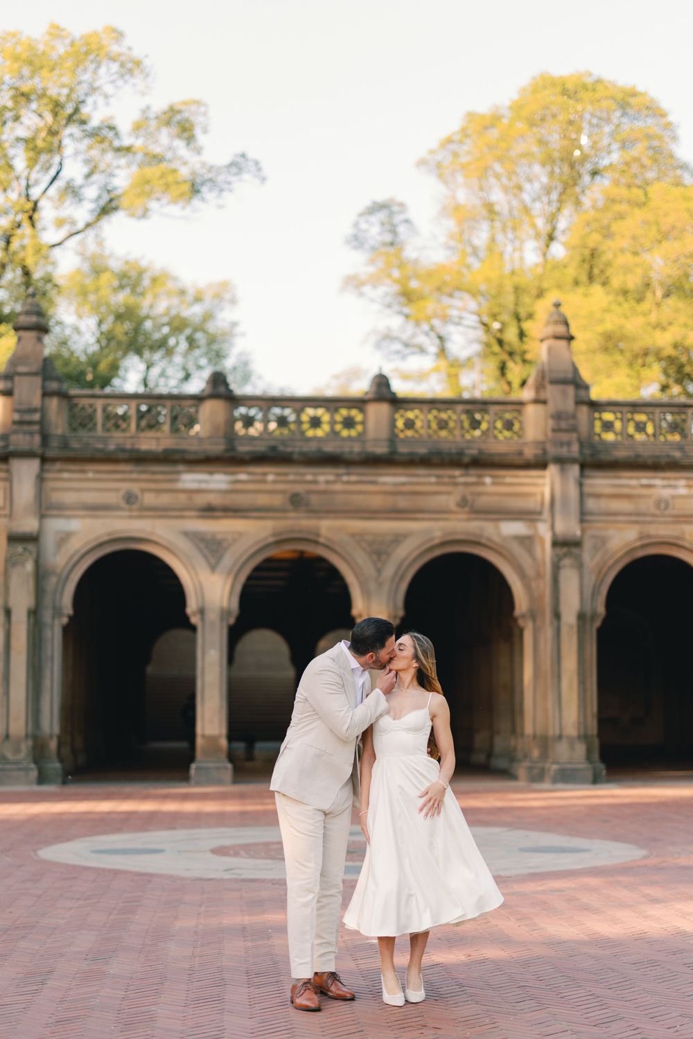 Couple sharing a kiss at Bethesda Terrace plaza in Central Park, New York City.