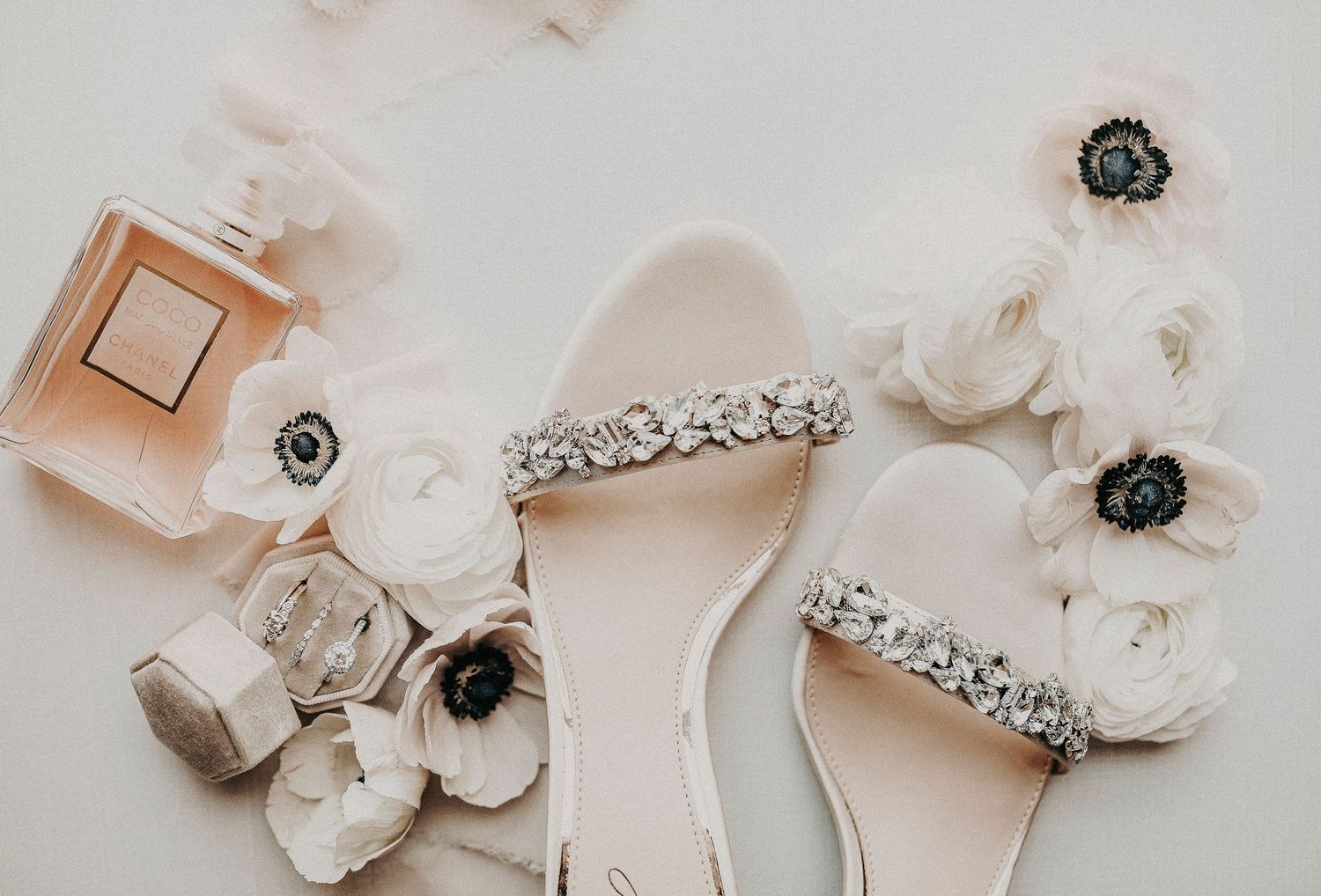 romantic wedding flat lay featuring invitation suite, wax seals, and delicate calligraphy styling