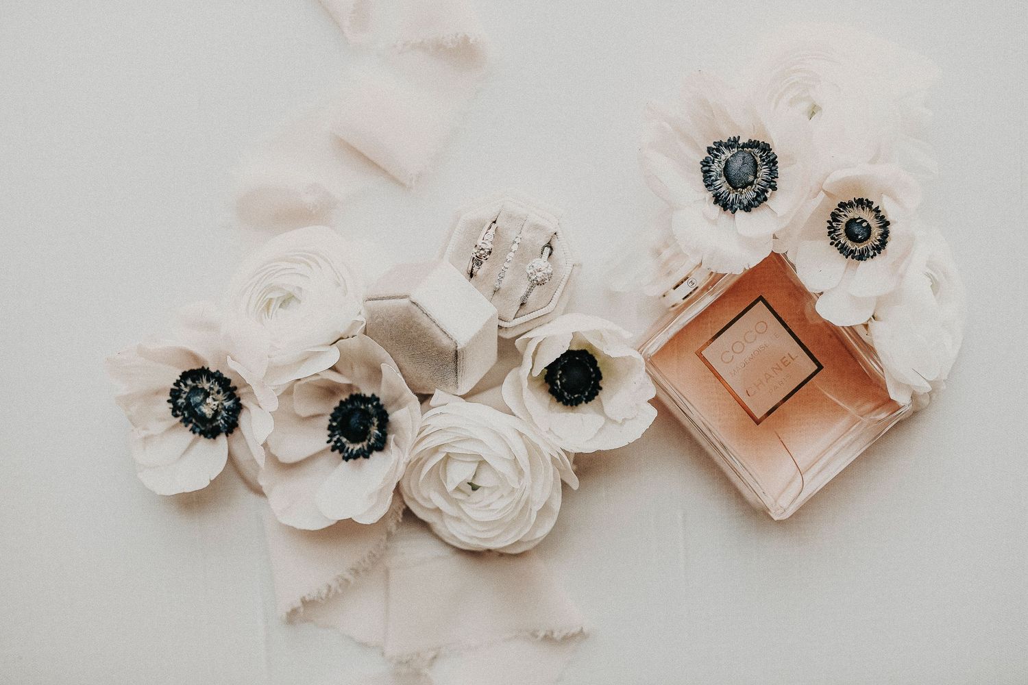 luxury wedding flat lay with invitation suite, rings, and silk ribbon styled by April Pinto Photography in Denton Texas