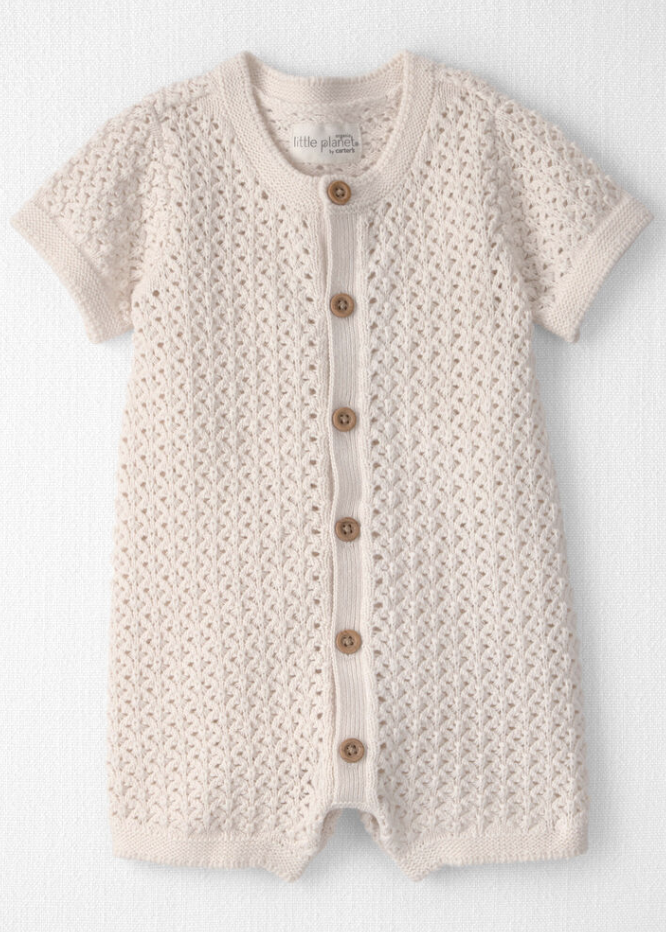 Cream knit baby romper with short sleeves, button front, and open-weave texture pattern.