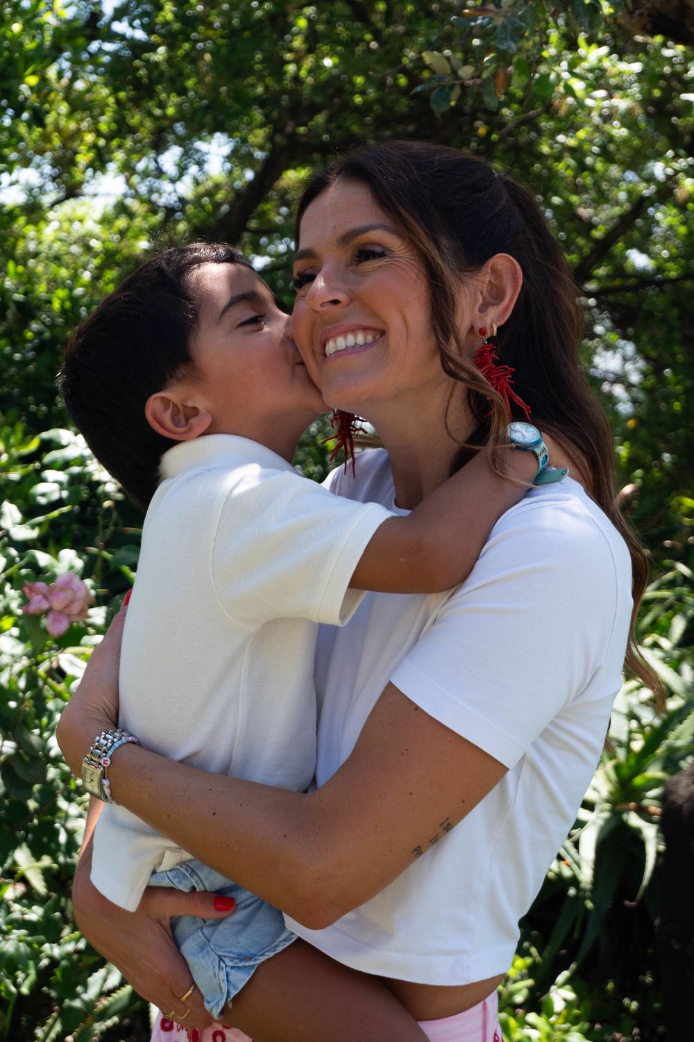 Small boy kissing his mother on the cheek