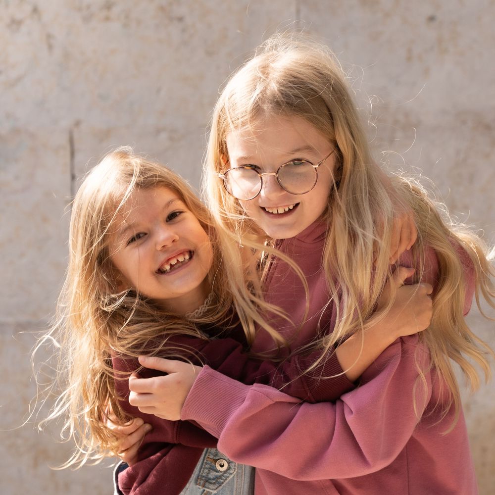 Two girls hugging and smiling