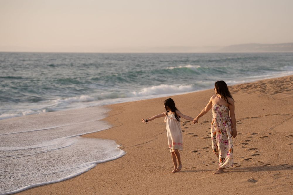 Mother and daughter on the beach in evening sunlight