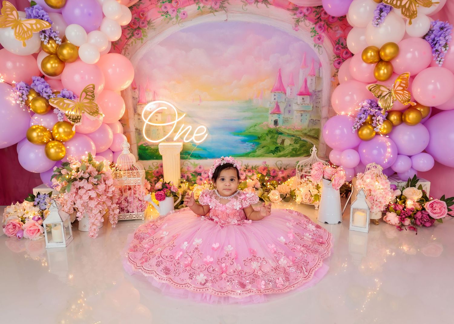 Luxury smash cake birthday photoshoot in Worcester MA with custom pink balloon décor and strawberry themed backdrop
