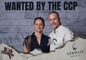 Man and woman smiling at Wanted by the CCP Best of Charleston Germain Dermatology photo booth.