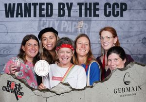 Six women smiling together at the Wanted by the CCP Best of Charleston Germain Dermatology booth.