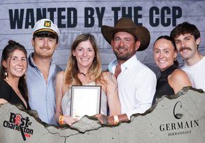 Group of six people pose with award at Best of Charleston CCP party, two wearing hats.
