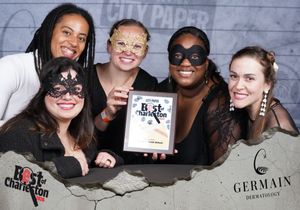 Five women wearing masquerade masks celebrate with Best of Charleston award at CCP party.