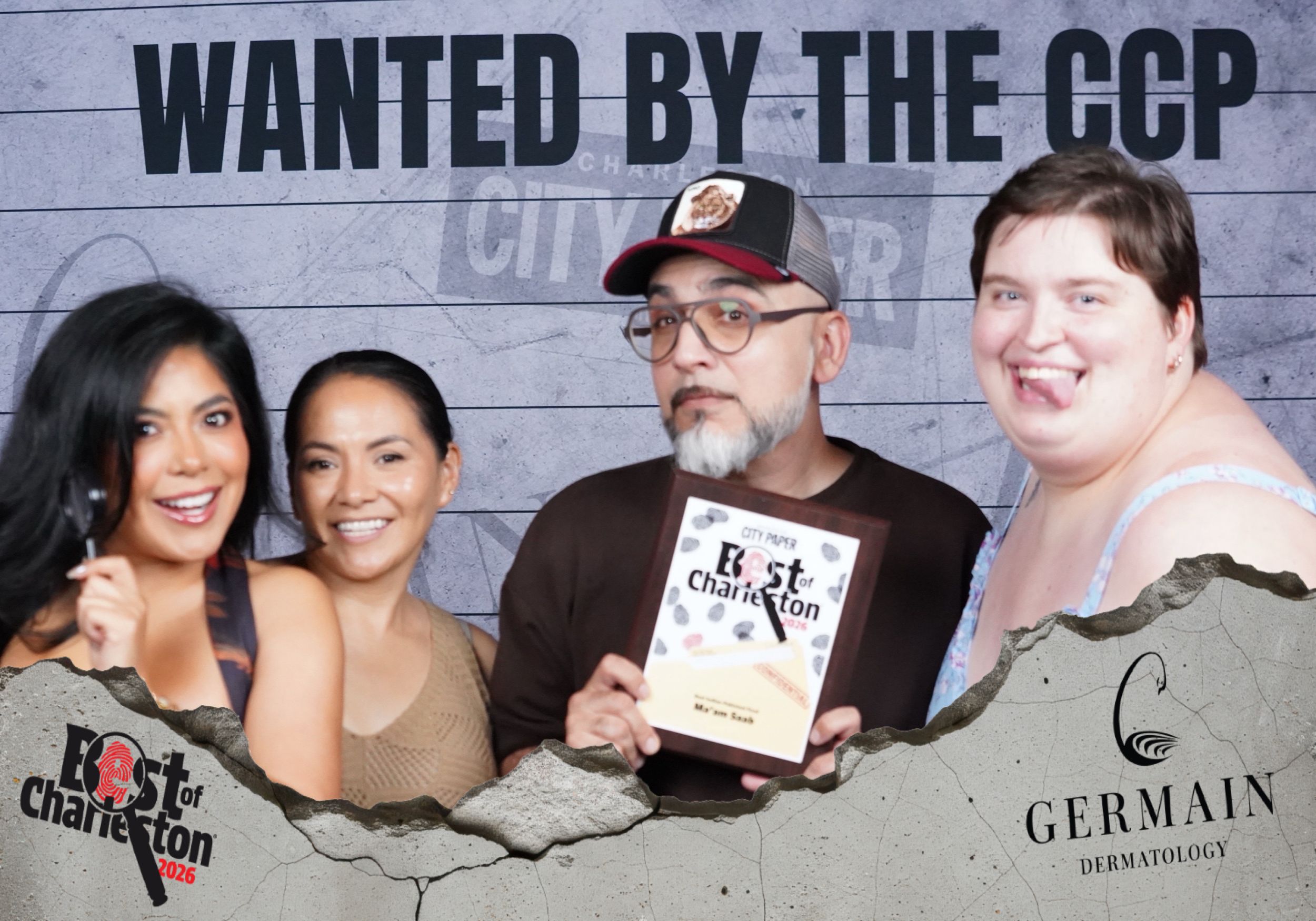 Four people pose together holding a Best of Charleston award plaque at a Germain Dermatology event.