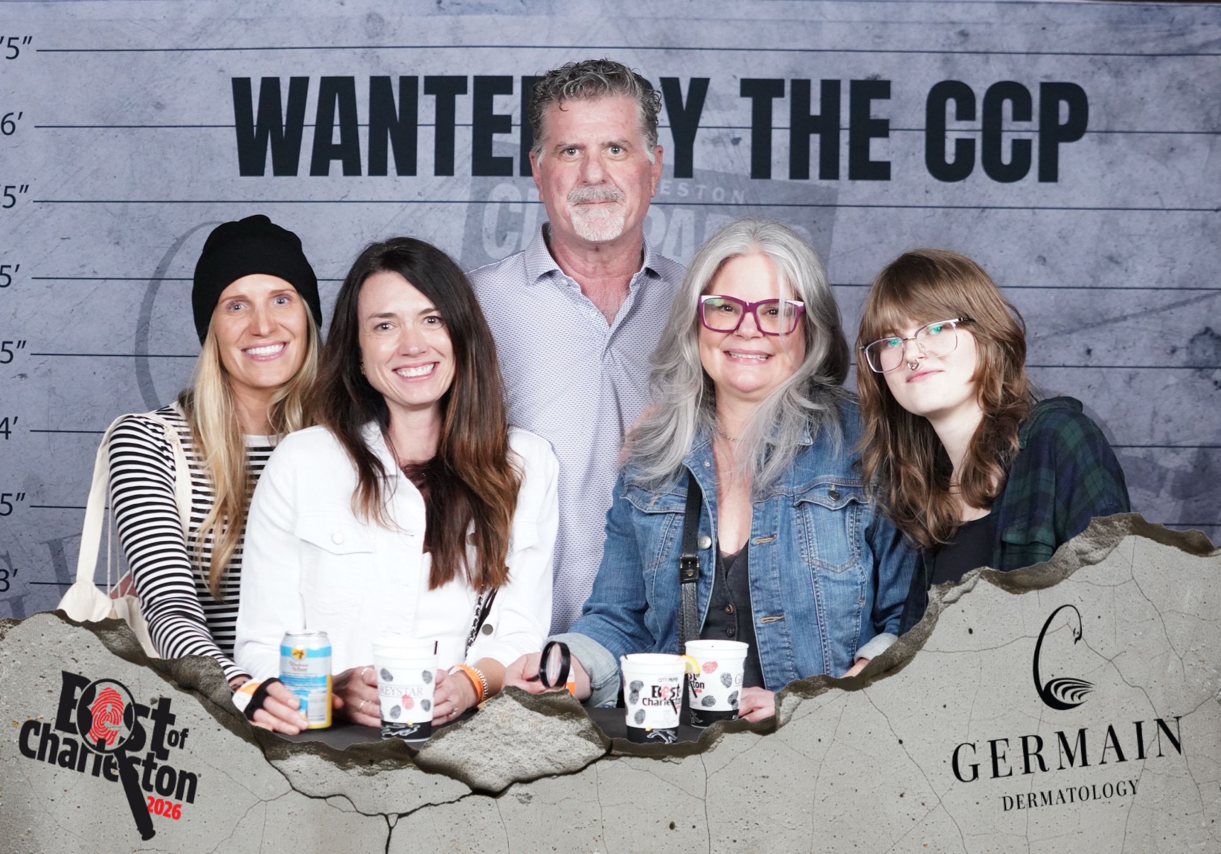 Five people pose smiling in front of a Wanted by the CCP sign at a Best of Charleston event sponsored by Germain Dermatology.