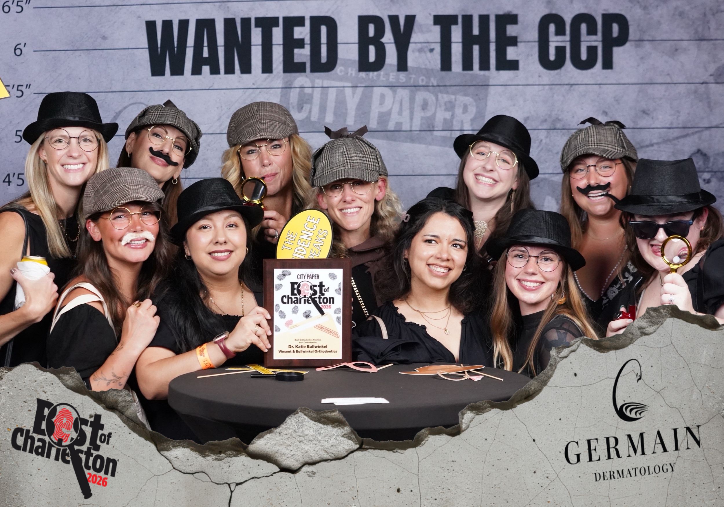 Group of women posing at Best of Charleston CCP award event, wearing detective hats and fake mustaches.