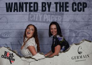 Two women pose at a Best of Charleston CCP City Paper wanted photo booth event.