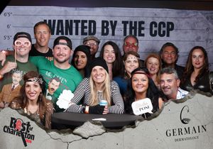 Large group poses together at Best of Charleston Wanted by the CCP themed photo booth event.