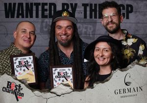 Four people smile holding Best of Charleston awards at a City Paper CCP event photo booth.