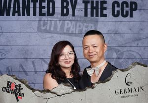 Smiling couple posing together at the Wanted by the CCP Best of Charleston City Paper event.