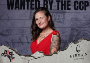 Woman in red dress poses at Best of Charleston CCP Wanted event with Germain Dermatology sponsorship.