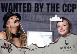 Two women pose with fun props at a Best of Charleston City Paper CCP awards photo booth.