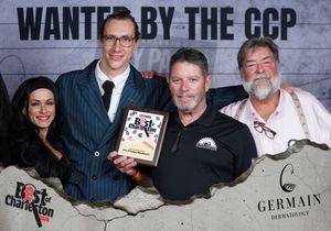 Four people posing with Best of Charleston award at Wanted by the CCP photo booth event.