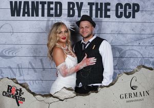 Stylish couple poses together at the Wanted by the CCP Best of Charleston photo booth.